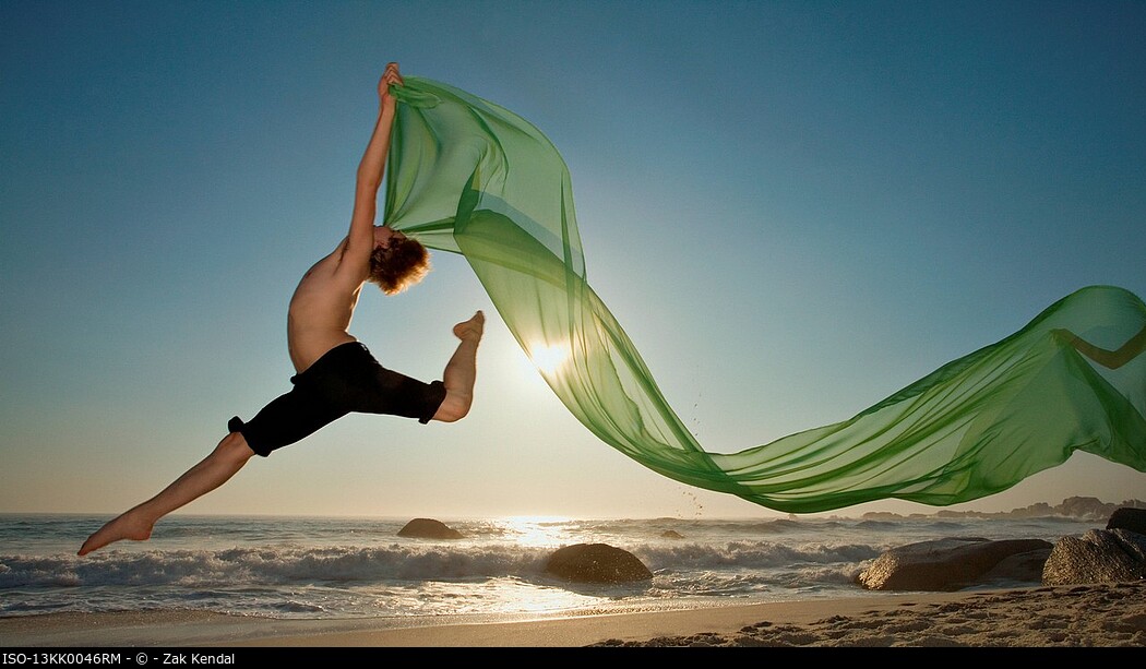 Dancer leaping on a beach