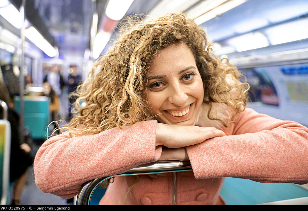 woman in public transport metro train, in Paris, France.