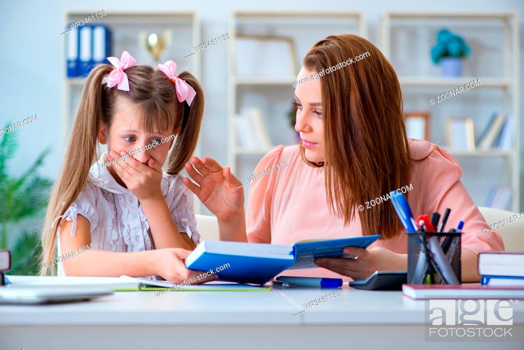 Stock Photo: Mother helping her daughter to do homework.