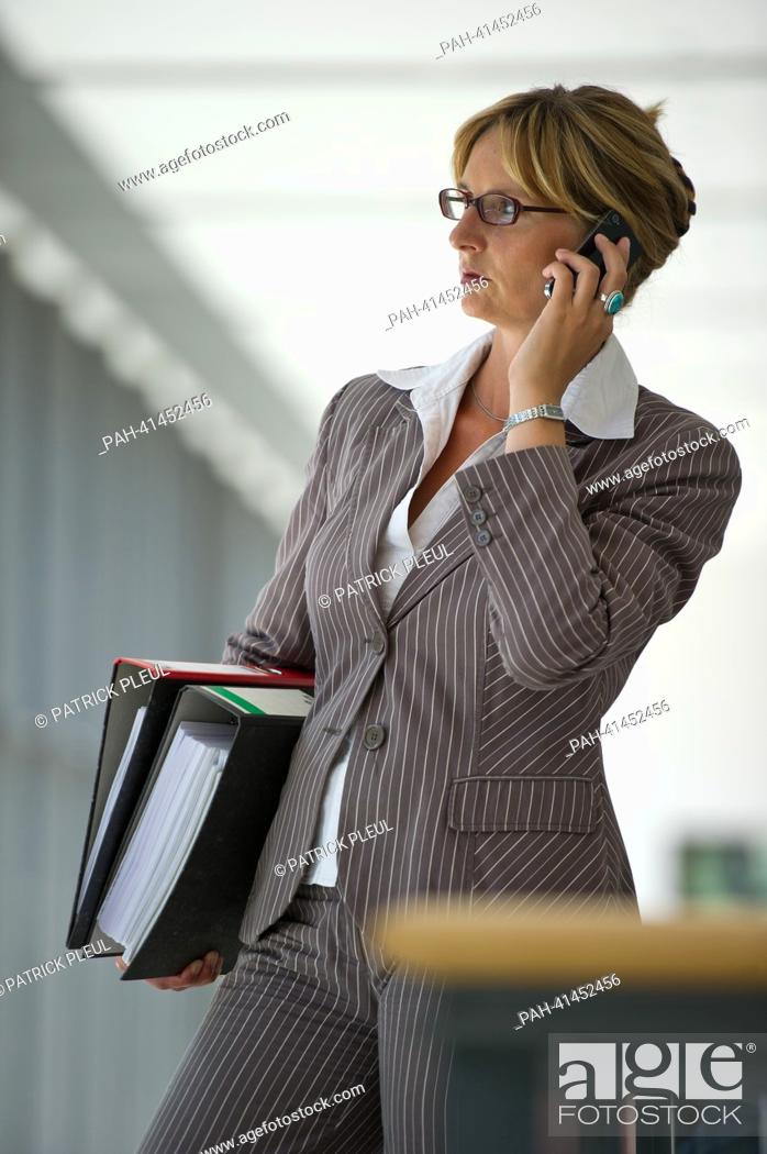 Stock Photo: (ILLUSTRATION) An illustration shows a business woman with a folder, laptop and a smartphone in Frankfurt Oder, Germany, 31 July 2013.