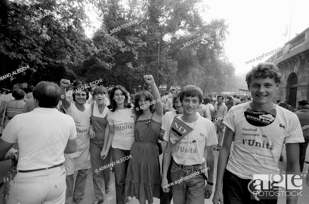 Stock Photo: Festa dell'Unità. Young people greeting with raised fist at Festa dell'Unità in Parco Sempione. Milan, September 1979.