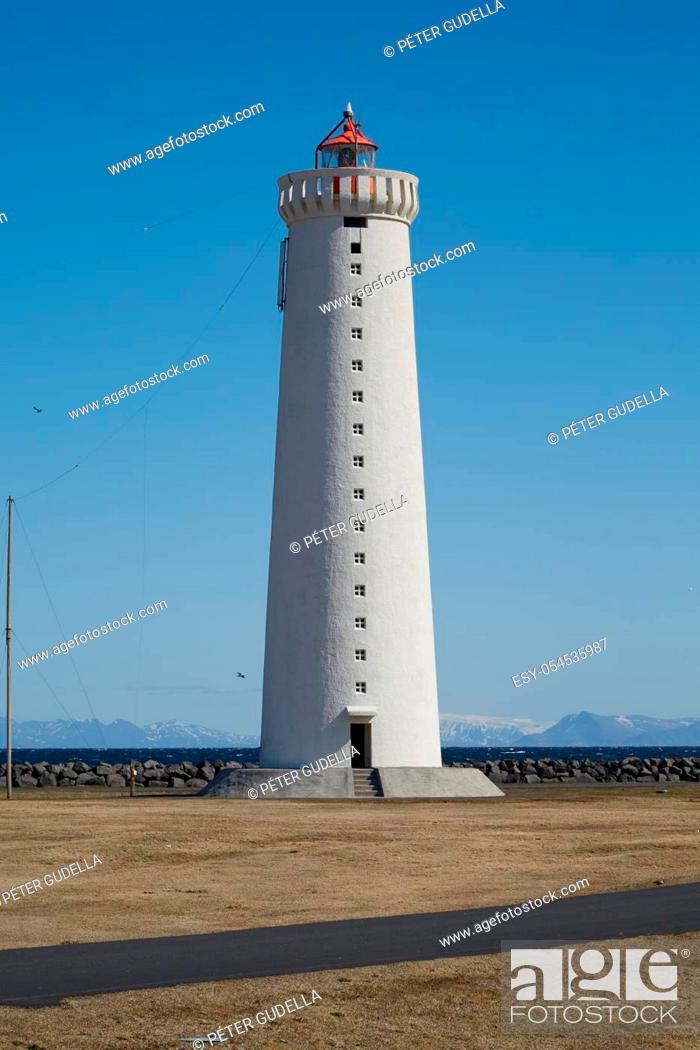 Stock Photo: Small lighthouse on the tip of a peninsula.