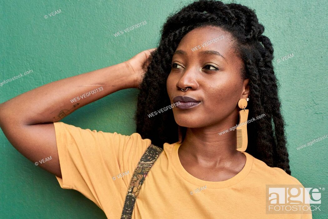 Stock Photo: Portrait of young woman with nose piercing and dreadlocks.