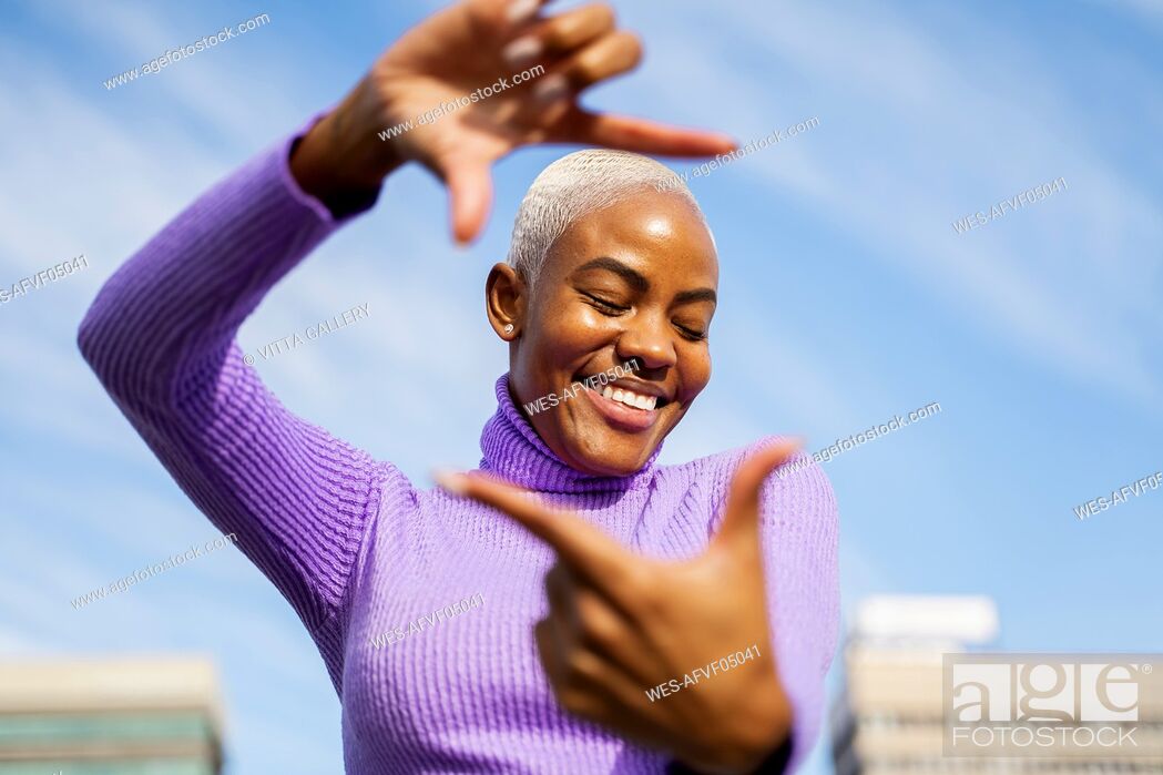 Stock Photo: Portrait of mature woman shaping frame with her fingers.