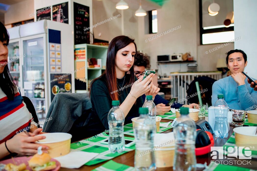 Stock Photo: Male and female business team having working lunch at cafe table.