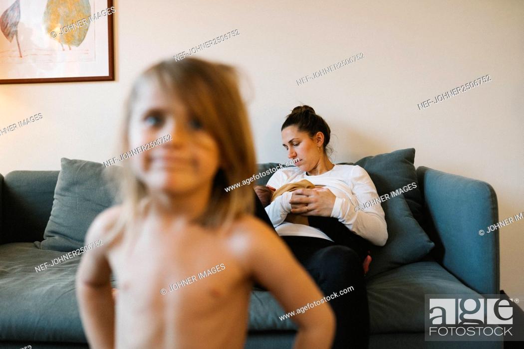 Stock Photo: Mother with baby on sofa.