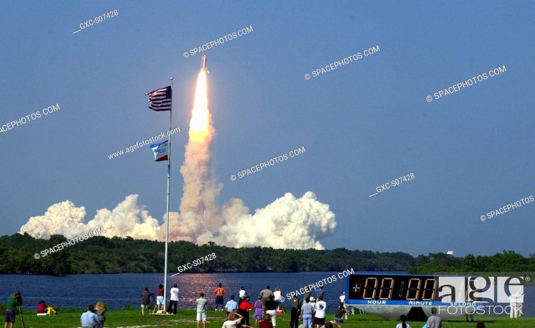 Stock Photo: 08/10/2001 -- As Space Shuttle Discovery roars into the blue sky over the Space Coast, the brilliant flames of its engines and boosters cast a pink glow in the.