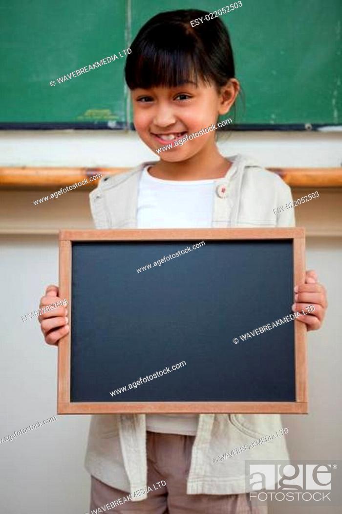 Stock Photo: Portrait of a girl holding a school slate.