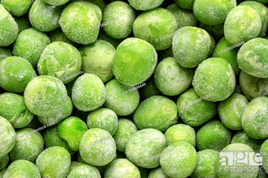 Stock Photo: closeup background of frozen green peas.
