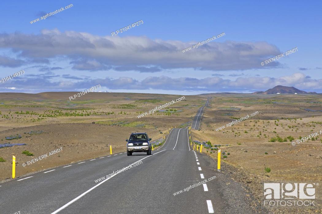 Stock Photo: Lonely car driving the Highway 85 / Norðausturvegur / Route 85 in summer, primary road in Nordurland eystra, northeastern Iceland.