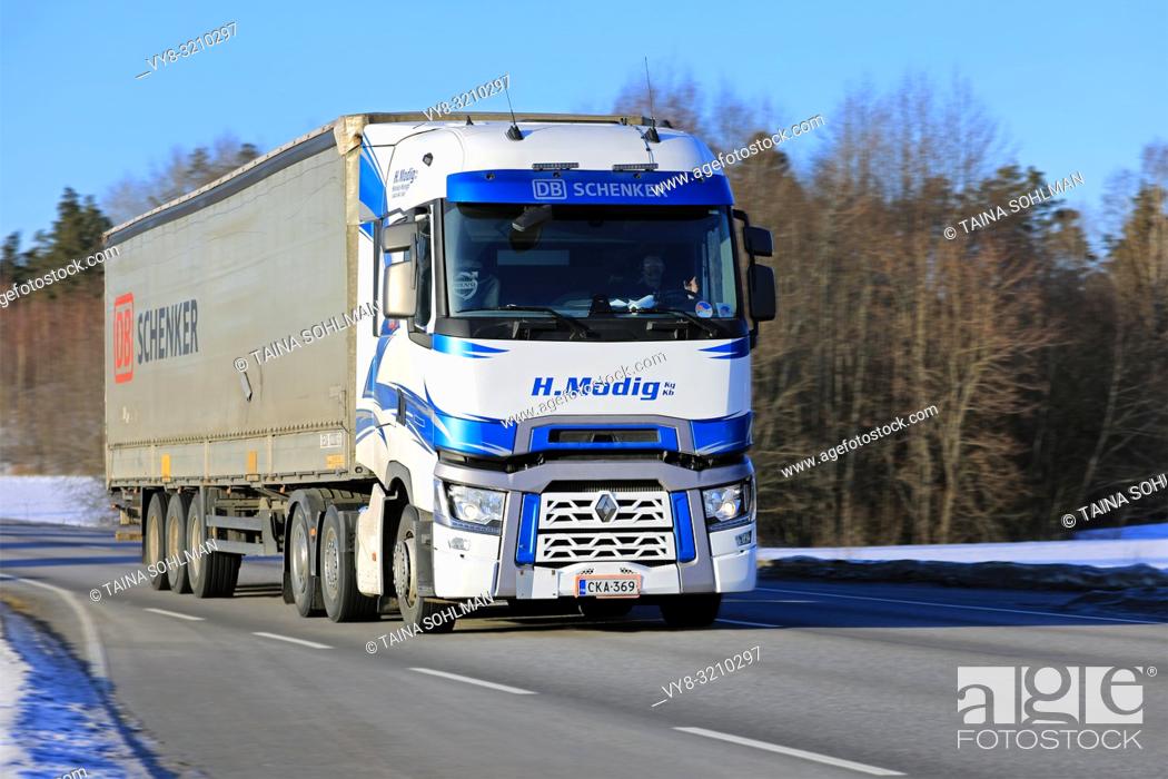 Stock Photo: Salo, Finland - March 2, 2018: Blue and white Renault Trucks T of Helmer Modig Oy pulls DB Schenker trailer on road at speed on sunny day of winter.