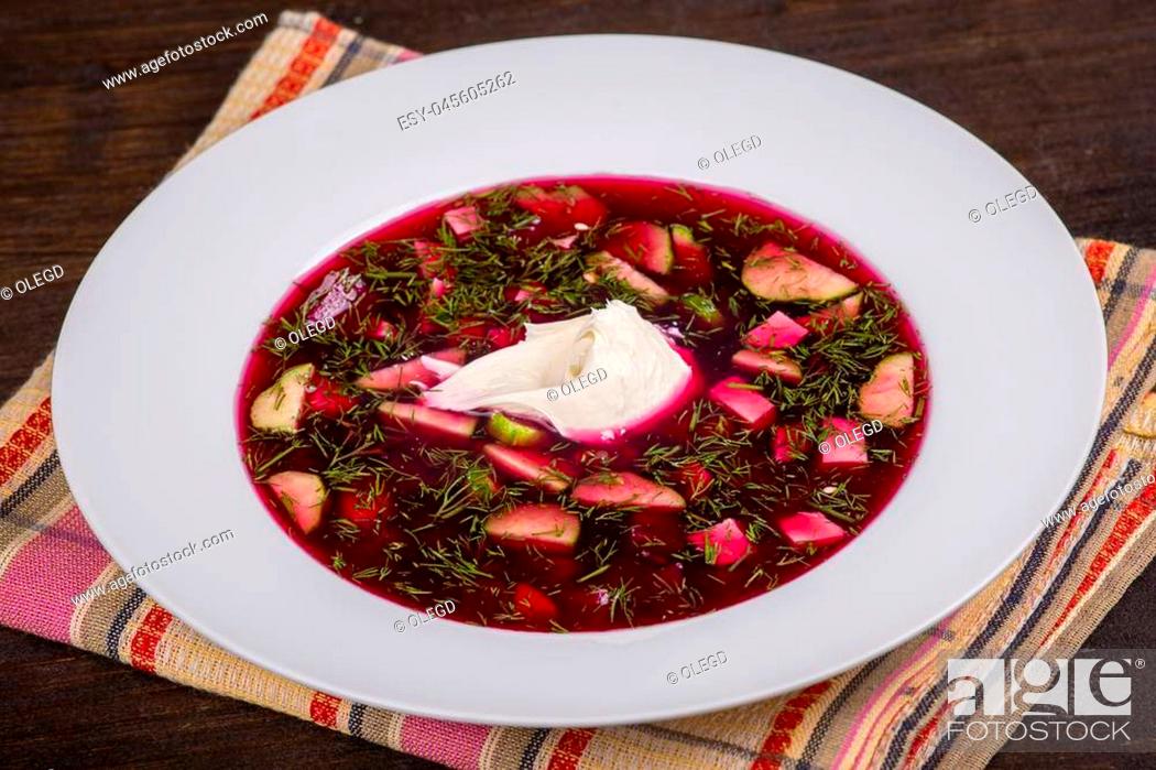 Stock Photo: Cold beetroot soup on the table. Close up.