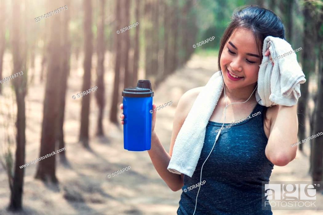 Stock Photo: Sport beautiful young woman girl lifestyle exercise healthy drinking water after running workout in forest nature park with copy space.