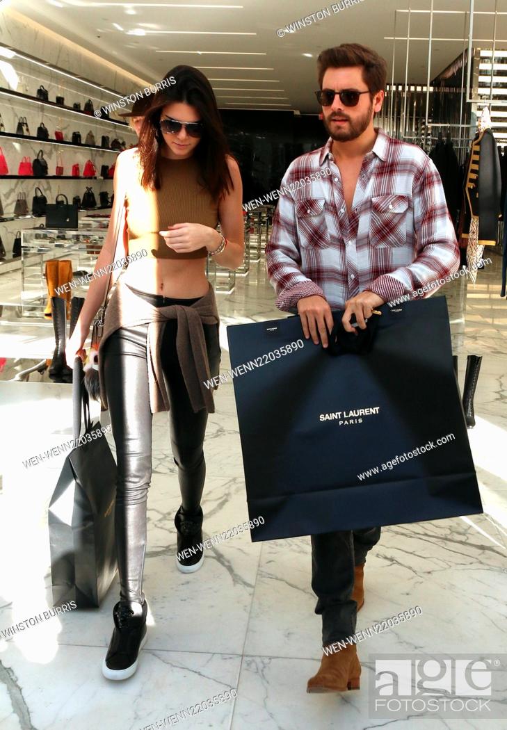 Kendall Jenner and Scott Disick holding Saint Laurent bags