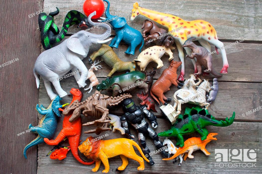 Animals, dinosaurs & soldier bunch of toys laying on dirty old wooden table  upper view, Stock Photo, Picture And Low Budget Royalty Free Image. Pic.  ESY-032288146 | agefotostock