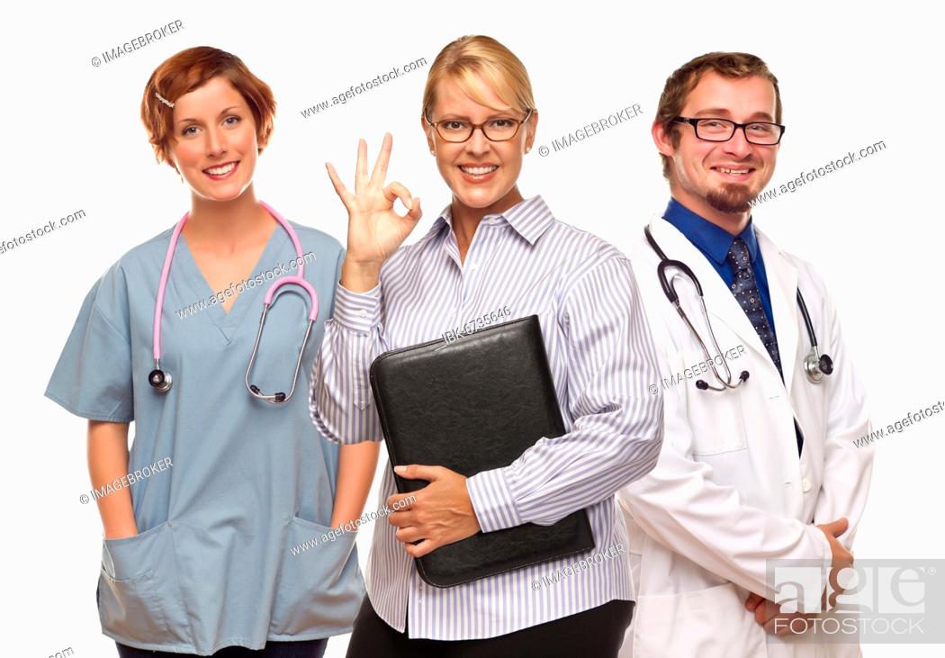 Imagen: Businesswoman making okay hand sign with two doctors or nurses isolated on a white background.