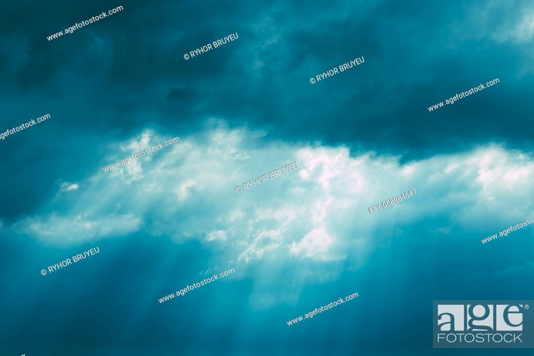Imagen: Sunrays Through Blue Rainy Dramatic Sky. Natural Abstract Background.