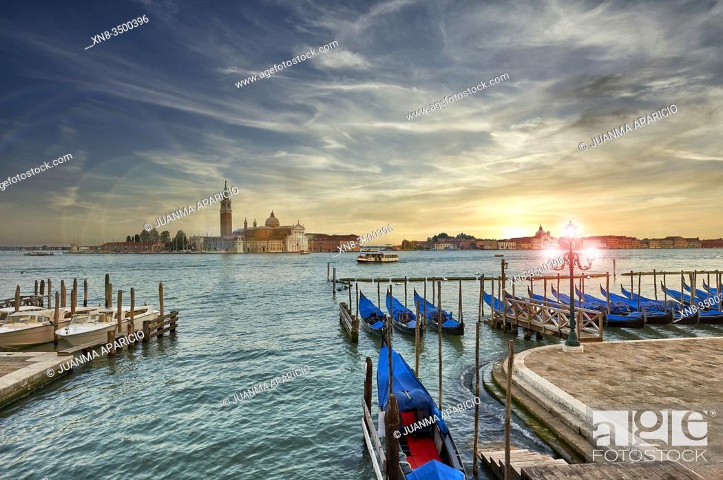 Stock Photo: Sunset view of gondolas at St Mark's Square with the island of San Giorgio Maggiore behind , with its church front designed by Andrea Palladio and begun in 1566.