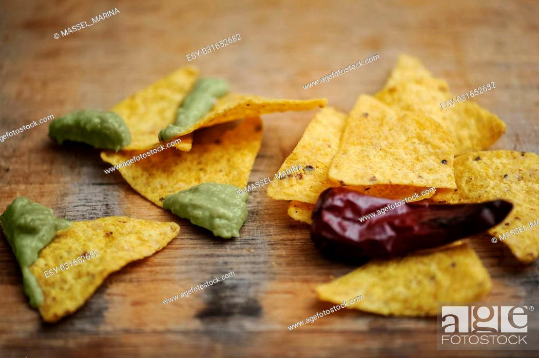 Stock Photo: homemade guacamole with corn chips top view on rustic wooden table.