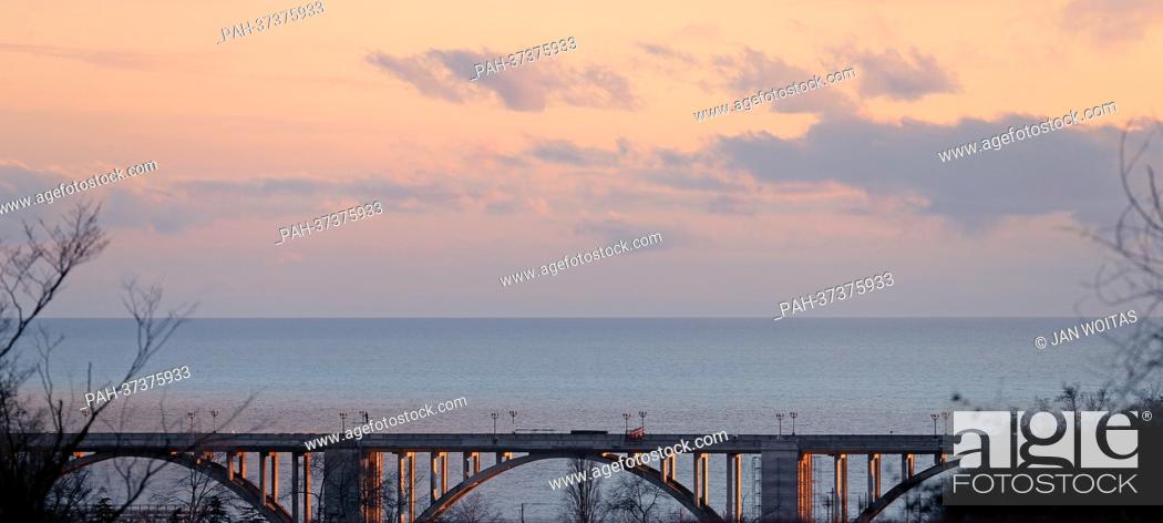 Stock Photo: A bridge spanns the coastal road M27 along the Black Sea coast at dusk near Sochi, Russia, 5 February 2013. The Winter Olympics are going to take place in the.