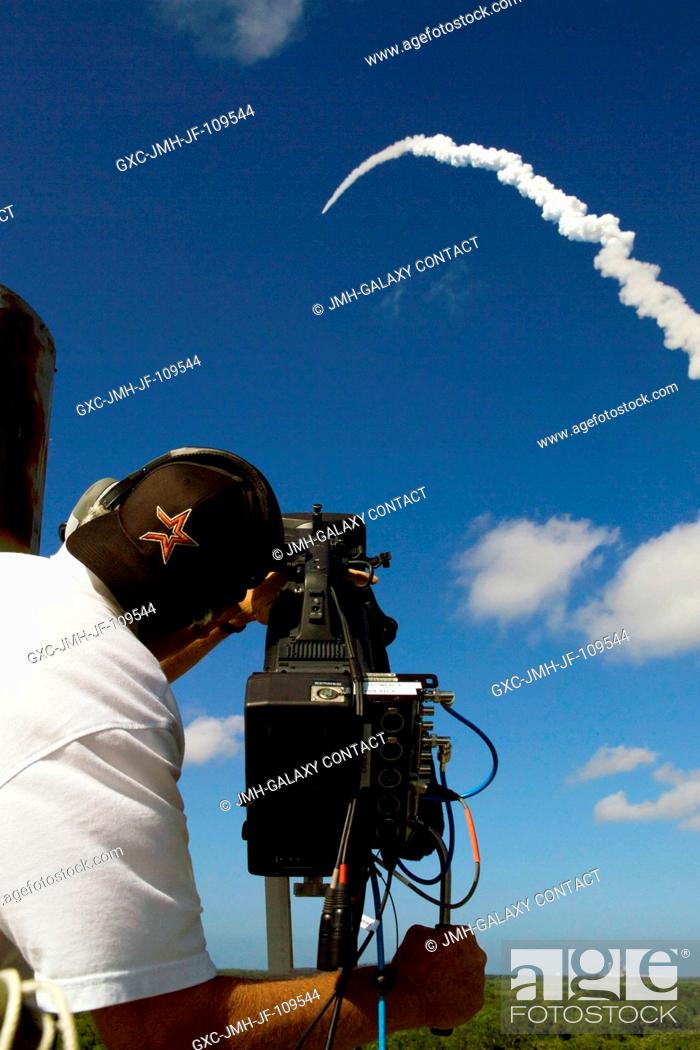 Stock Photo: A videographer with NASA's Kennedy Space Center (KSC) captures the launch of Space Shuttle Discovery on its STS-124 mission to the International Space Station.