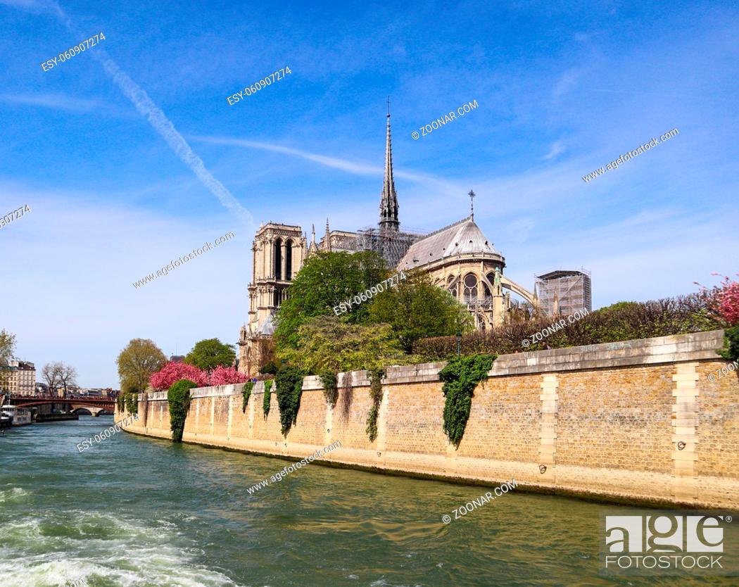 Stock Photo: Paris / France - April 05 2019. Notre Dame Cathedral over Seine river in spring. Before the fire.