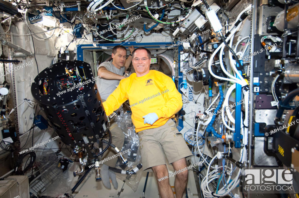 Stock Photo: NASA astronauts Kevin Ford (foreground), Expedition 34 commander; and Tom Marshburn, flight engineer, work with the Combustion Integrated Rack (CIR) Multi-user.