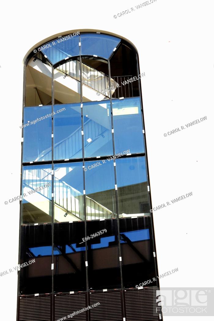 Stock Photo: Window and stairwell of Maankwartier. cloudless blue sky reflected in window.