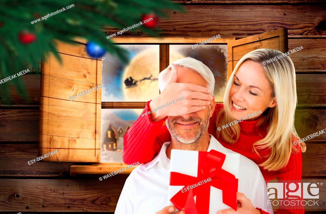 Stock Photo: Composite image of loving couple with gift.