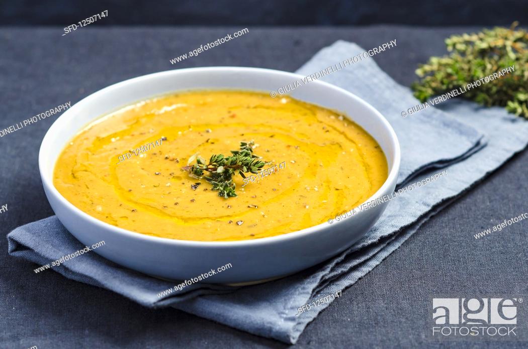 Stock Photo: Cream of pumpkin sauce with thyme, olive oil and coarsely ground pepper.