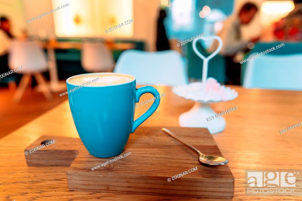 Stock Photo: Hot cappuccino coffee in coffee shop on wooden table, close angle.