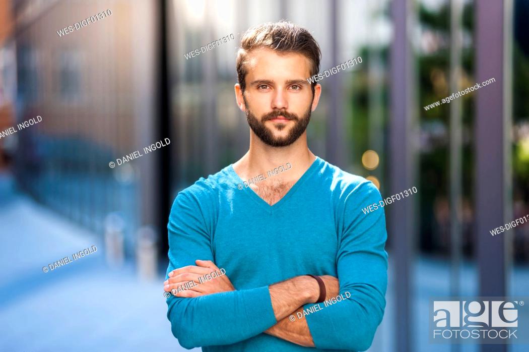 Stock Photo: Portrait of confident young man in the city.