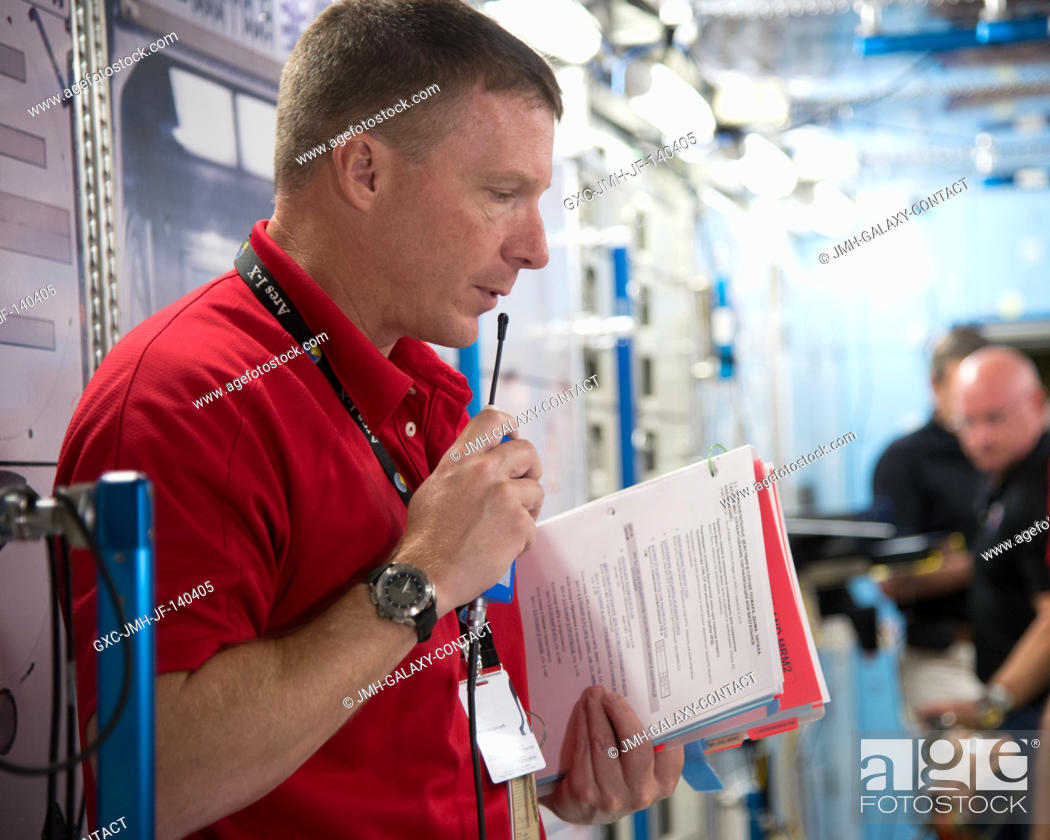 Stock Photo: NASA astronaut Terry Virts, Expedition 42 flight engineer and Expedition 43 commander, uses a microphone during an emergency scenario training session in an.