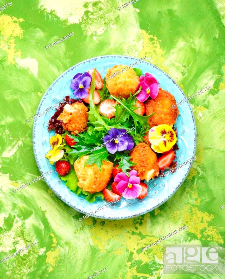 Stock Photo: Vitamin summer salad with strawberries, grilled cheese, arugula and flowers.Healthy food.Clean eating.