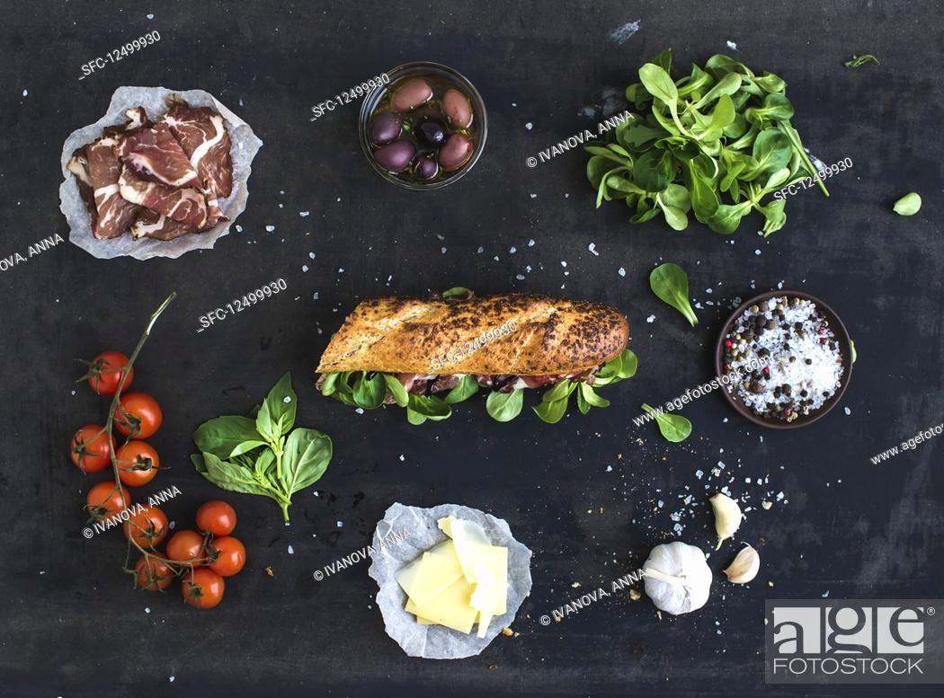 Stock Photo: Ingredients for sandwich with smoked meat, basil, arugula, olives, cherry-tomatoes, parmesan cheese, garlic and spices.