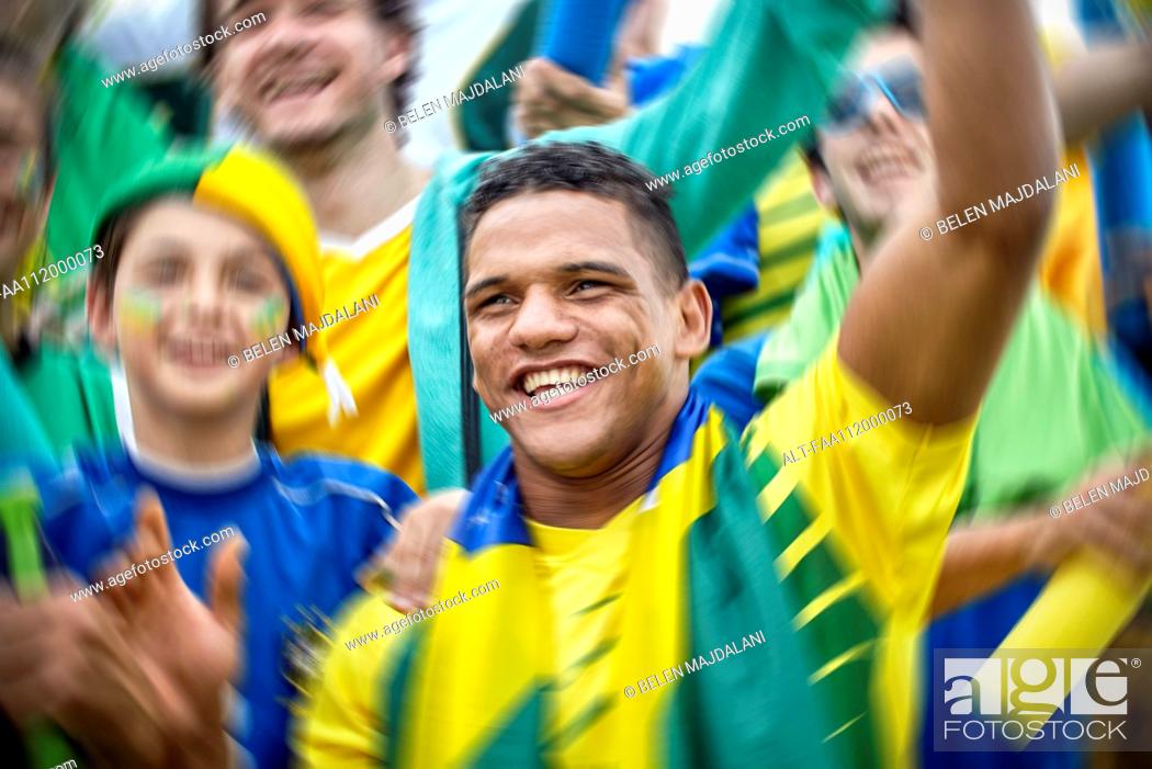 Stock Photo: Brazilian football fans cheering at football match.