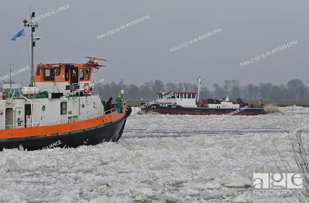 Stock Photo: 18 February 2021, Poland, Zatan Dolna: A Polish (l) and a German icebreaker navigate the German-Polish border river Oder north of Schwedt (Brandenburg).