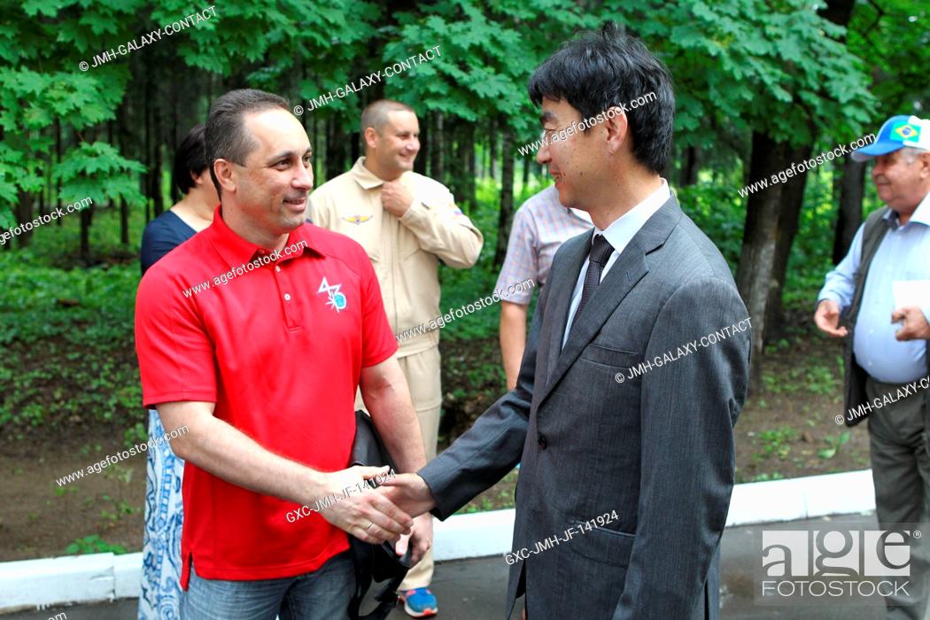 Stock Photo: At the Gagarin Cosmonaut Training Center in Star City, Russia, Expedition 4445 crewmember Kimiya Yui of the Japan Aerospace Exploration Agency (right) greets.