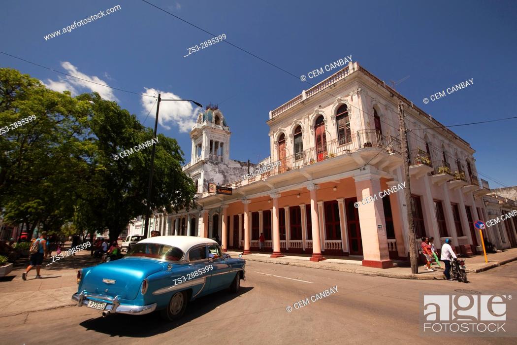 Stock Photo: View to the colonial buildings at the main avenue Prado at the town center with an old American car in the foreground, Cienfuegos, Cienfuegos Province, Cuba.