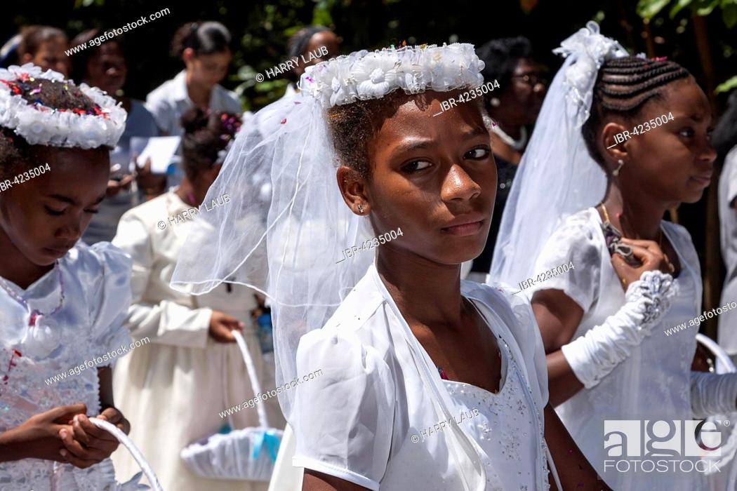 Stock Photo: Girl dressed in white, festive clothing, Catholic festival, parade, procession on the holiday of the Assumption, La Digue Island, Seychelles.
