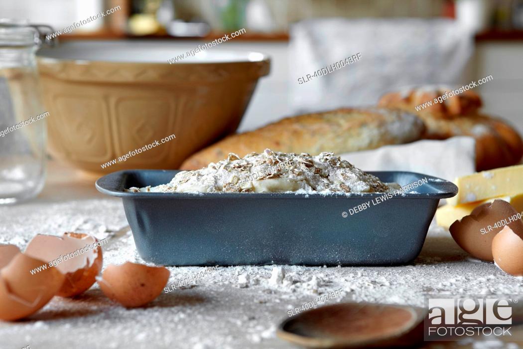 Stock Photo: Bread loaves and dough in messy kitchen.
