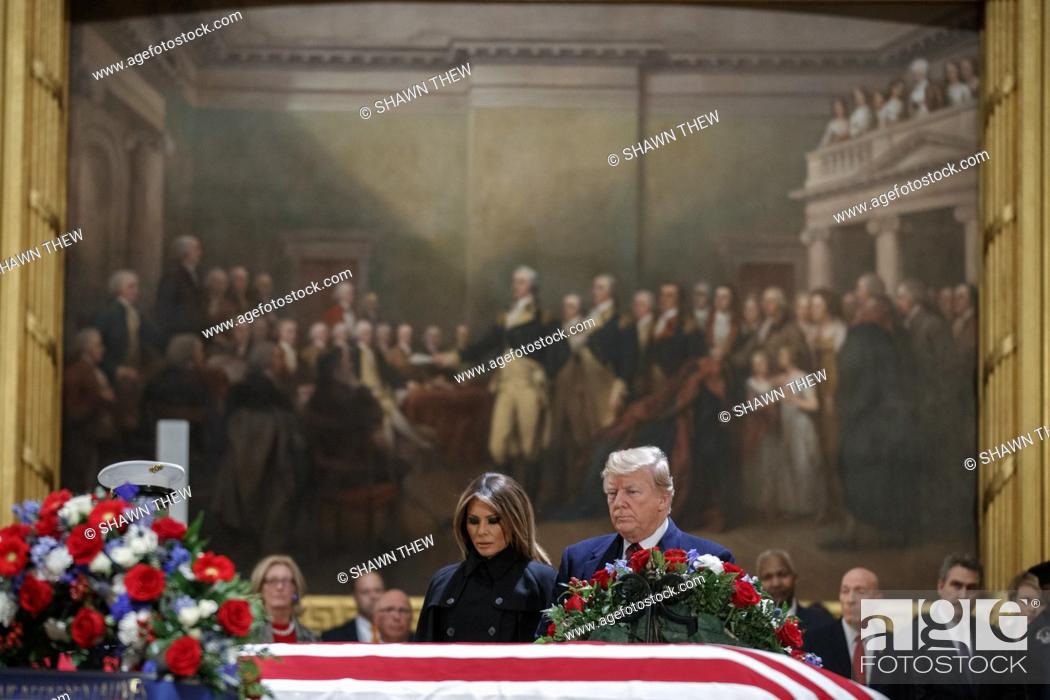 Stock Photo: US President Donald J. Trump and First Lady Melania Trump take a moment of silence at the casket containing the body of former US President George H.W.