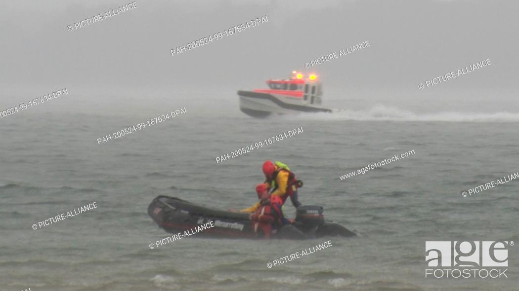 Stock Photo: 23 May 2020, Bavaria, Chiemsee: Boats of the water rescue service are on duty on the Chiemsee during storms. 22 people have been rescued from Chiemsee during a.