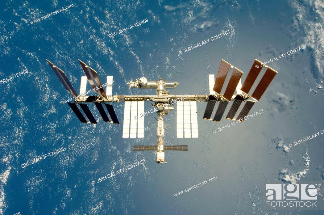 Stock Photo: Backdropped by a blue and white Earth, the International Space Station is seen from Space Shuttle Endeavour as the two spacecraft begin their relative.
