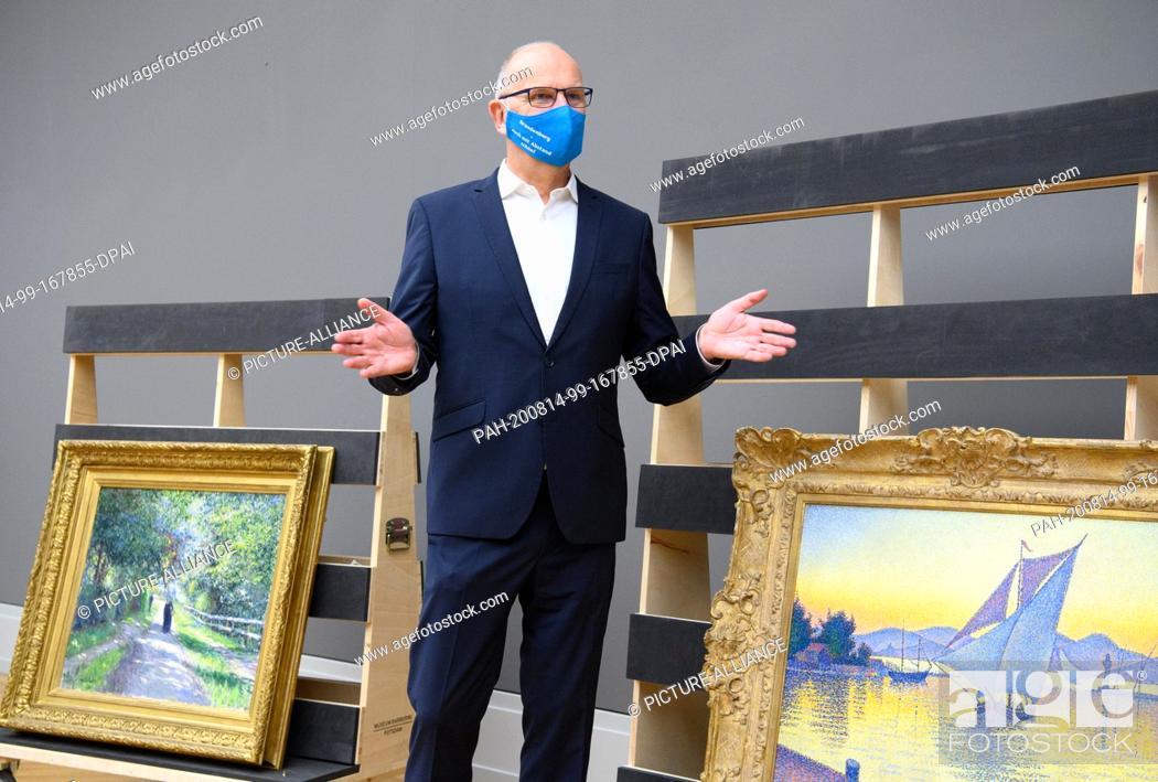 Stock Photo: 14 August 2020, Brandenburg, Potsdam: Dietmar Woidke (SPD), Prime Minister of Brandenburg, stands during his press tour with blue mouth-nose protection in the.