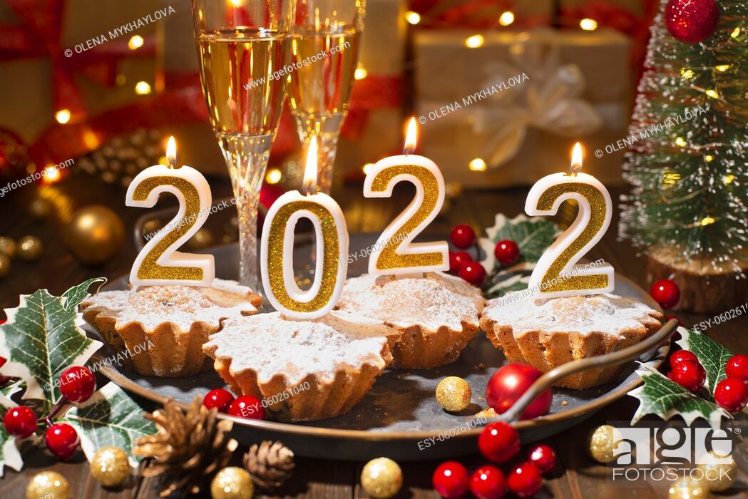 Stock Photo: Food tray with cupcakes new year candles and wineglasses.