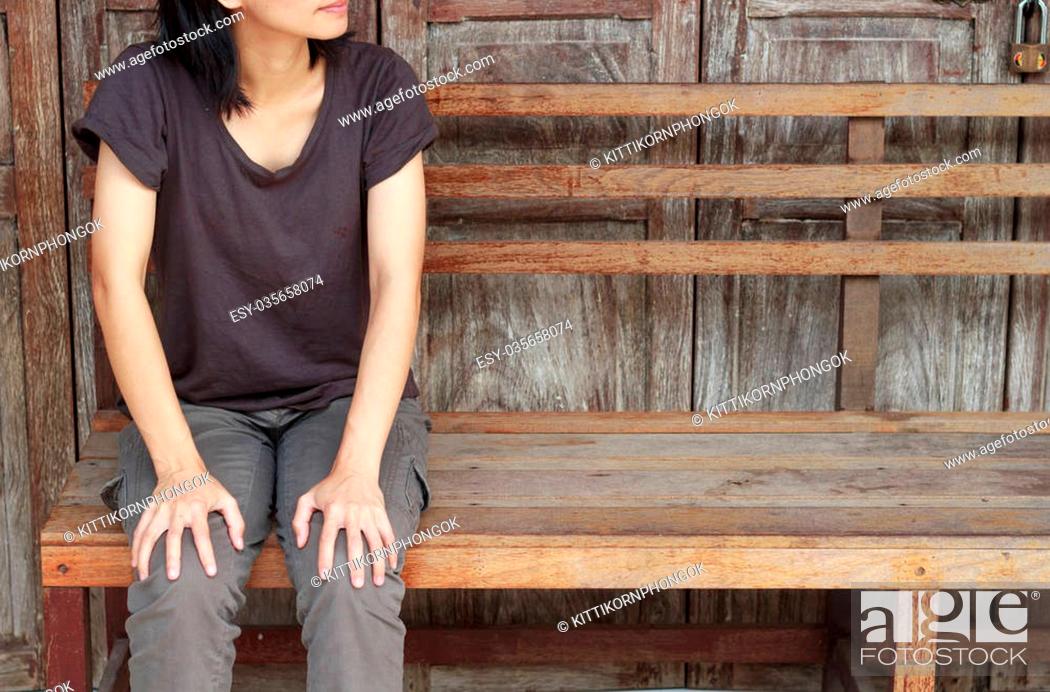 Stock Photo: Asian woman waiting some on wooden wall background.