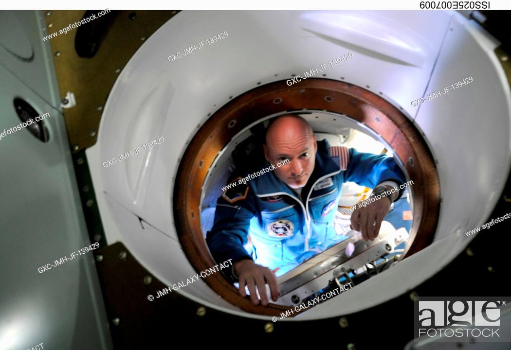 Stock Photo: NASA astronaut Scott Kelly, Expedition 25 flight engineer, is pictured inside the hatch area of the Soyuz TMA-01M spacecraft on docking day with the.