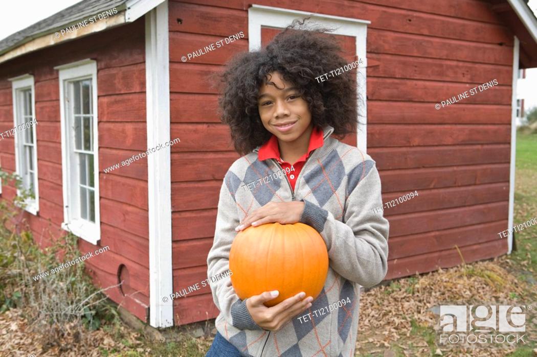 Stock Photo: Woman holding a pumpkin.