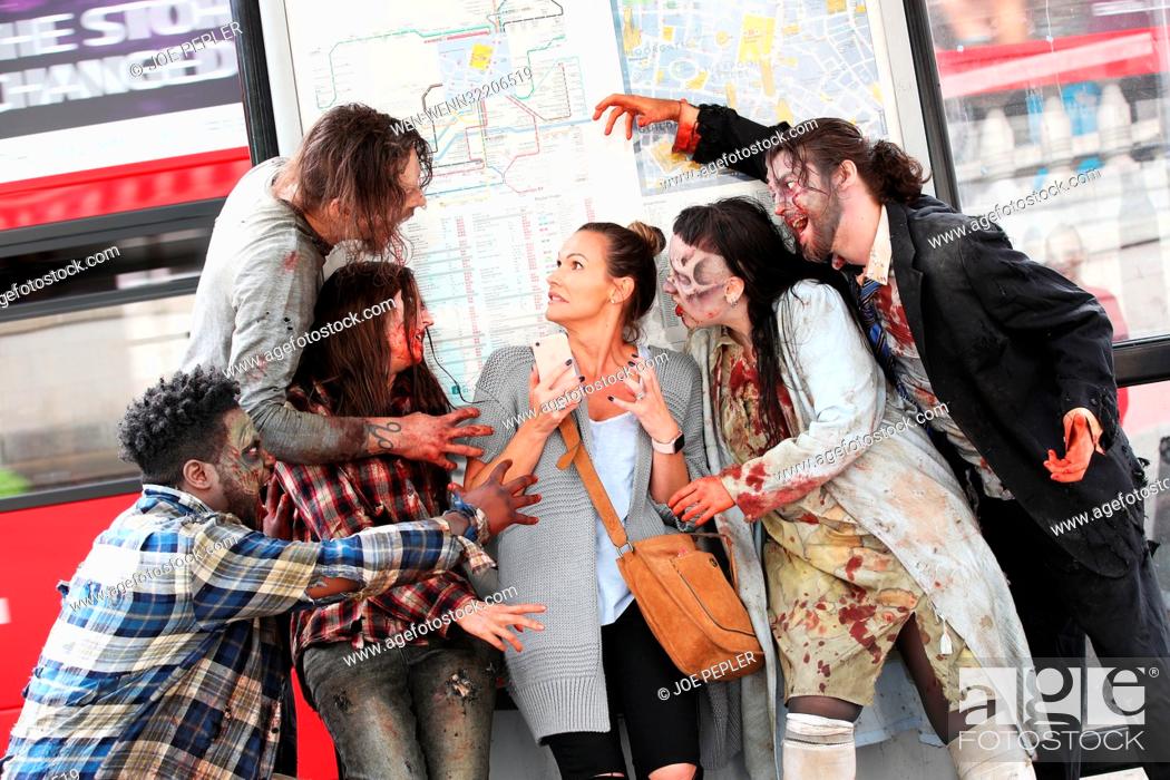 Stock Photo: ‘Zombies’ appear in a gory billboard in Shoreditch, London, to mark the arrival of two new The Walking Dead scare mazes at THORPE PARK Resort for its annual.